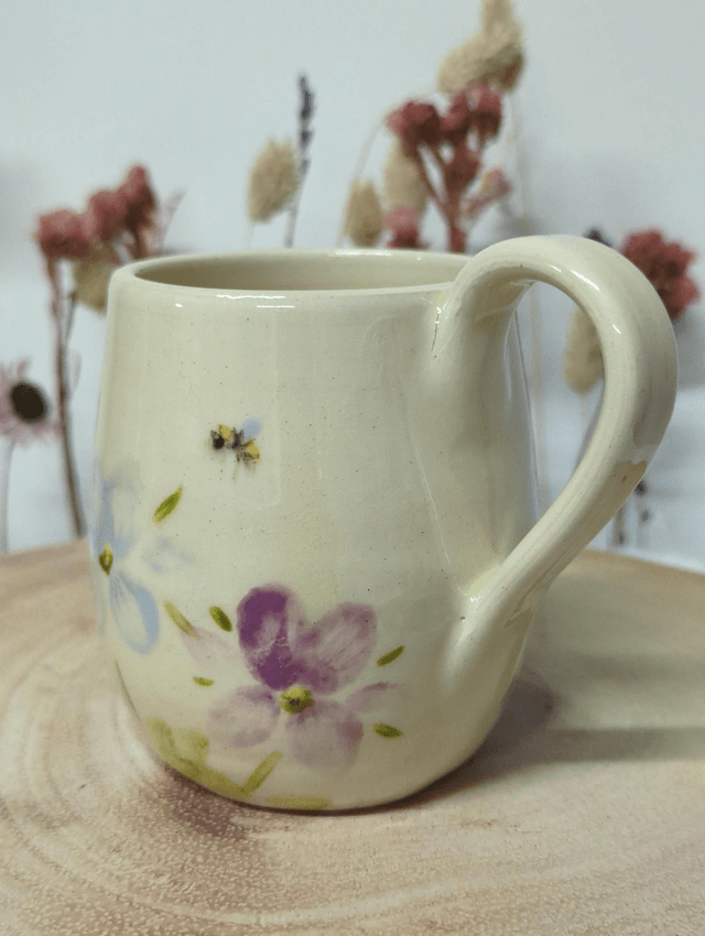 Hand thrown ceramic coffee mug with hand painted floral design