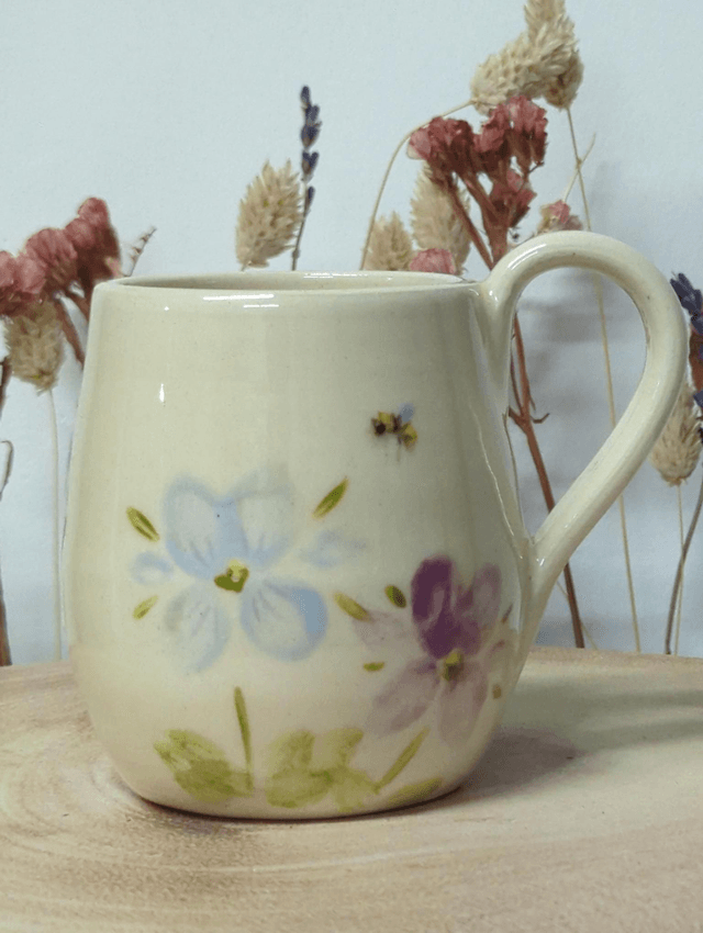 Hand thrown ceramic coffee mug with hand painted floral design