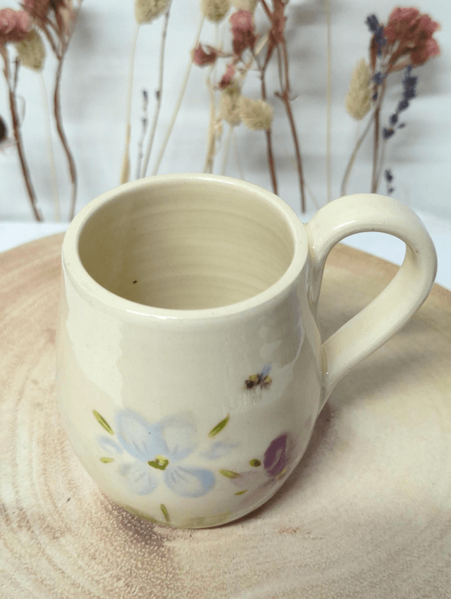 Hand thrown ceramic coffee mug with hand painted floral design